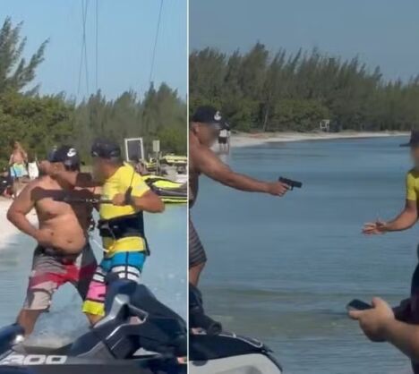 Banhista saca arma, aponta para velejador,