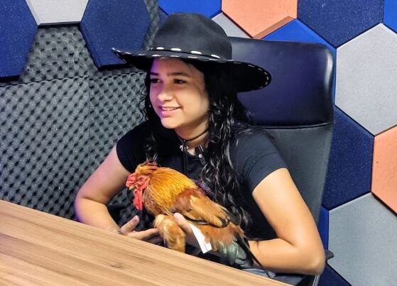 A influenciadora digital, Maria Pantaneira, com o seu galo de estimação no HNT Entrevista. 