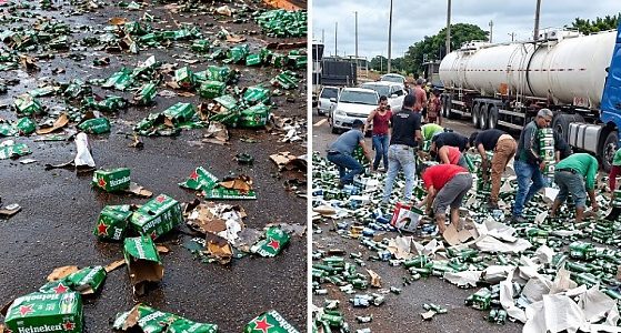 Caminhão carregado com cerveja tomba em rodovia e tem carga saqueada por populares
